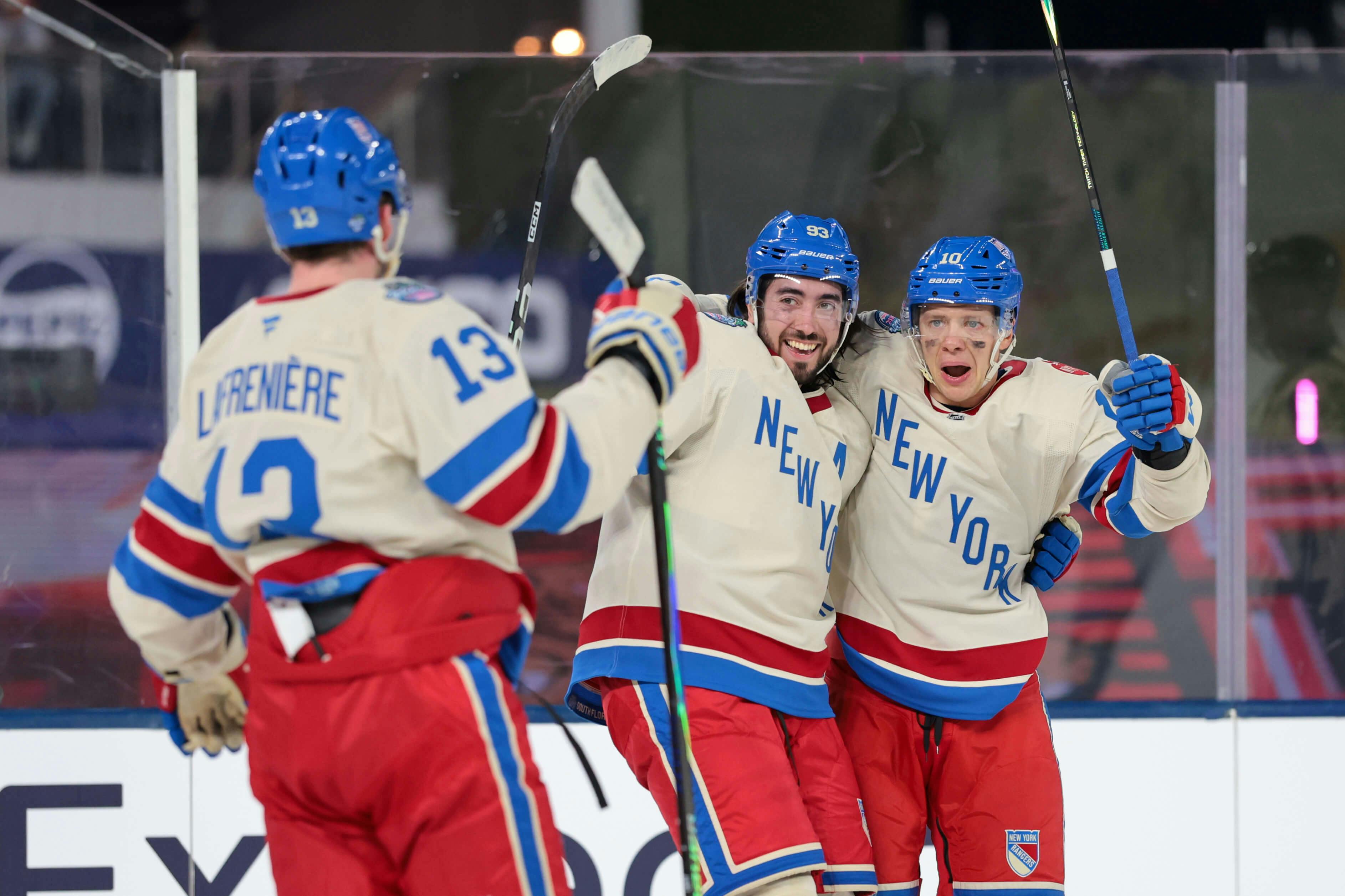 New York Rangers left wing Artemi Panarin (10) celebrates with Alexis Lafreniere (13) and Mika Zibanejad (93) after scoring a goal against the Florida Panthers in the 2026 Winter Classic at loanDepot Park. Sam Navarro-Imagn Im