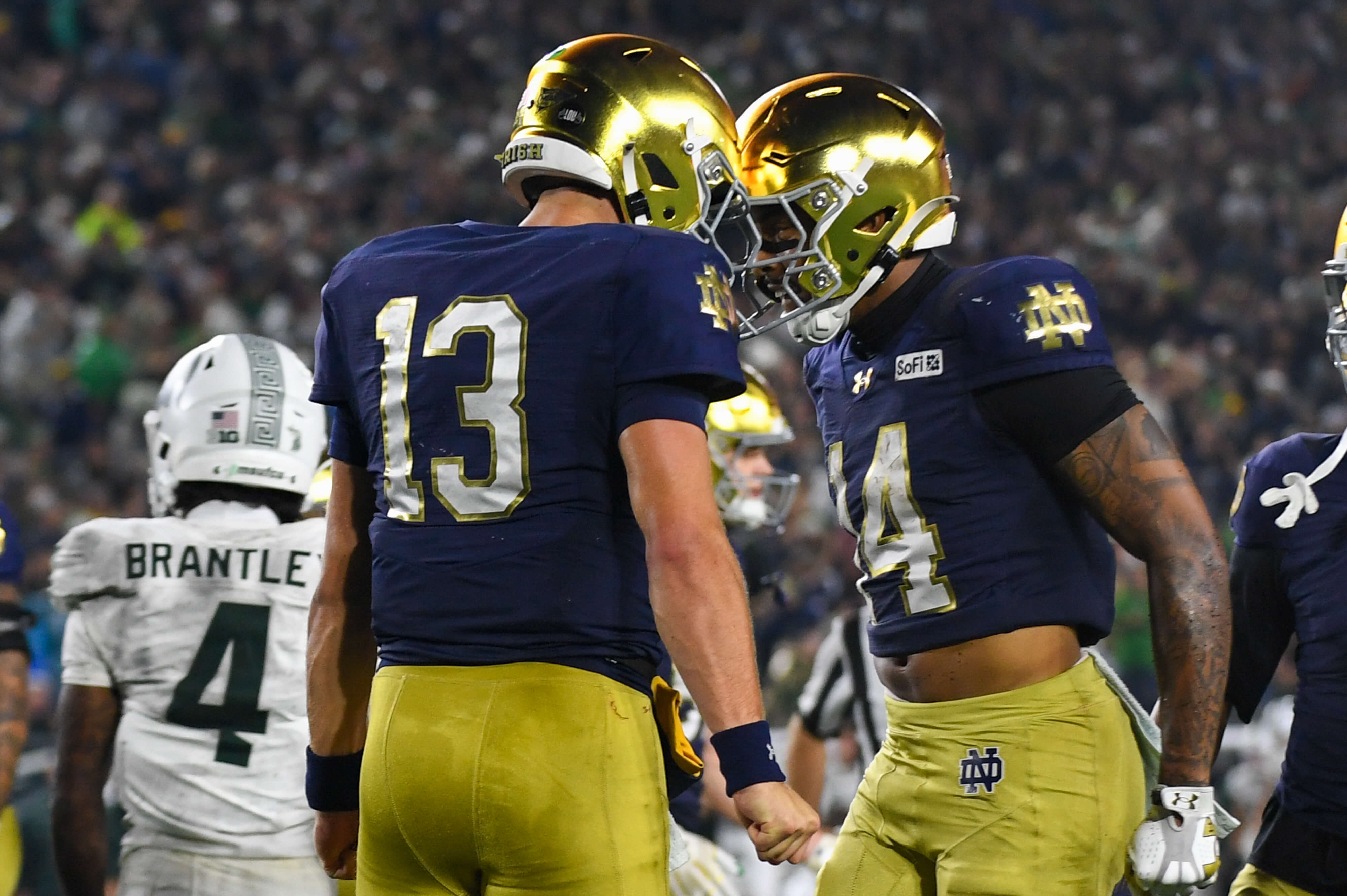Notre Dame vs BYU AI predictions, Notre Dame quarterback CJ Carr (13) and receiver Micah Gilbert (14) celebrate after a touchdown.