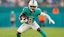 Miami Dolphins wide receiver Malik Washington (6) runs with the football.