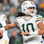 Green Bay Packers quarterback Jordan Love (10) directs a receiver