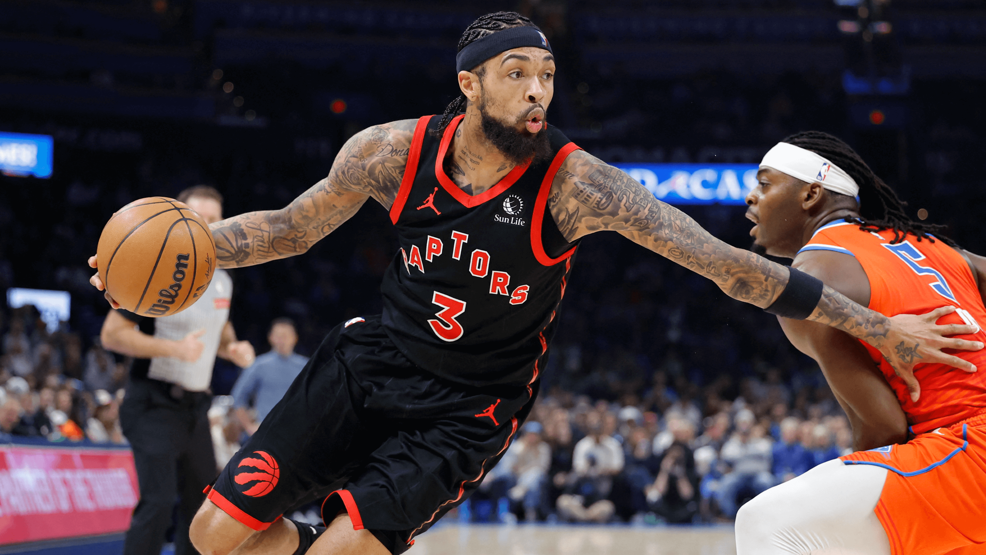 Brandon Ingram (3) dribbles past an Oklahoma City defender.