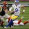 Los Angeles Rams quarterback Matthew Stafford (9) scrambles with the ball against the Cincinnati Bengals during the first quarter in Super Bowl LVI at SoFi Stadium.