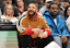 Recording artist Drake (gold jacket) reacts as Toronto Raptors forward Chris Boucher (25) is knocked over during the first half against the Oklahoma City Thunder at Scotiabank Arena. Mandatory Credit: John E. Sokolowski-Imagn Images