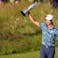Collin Morikawa celebrates with the Claret Jug on the 18th green following his final round winning the Open Championship golf tournament.