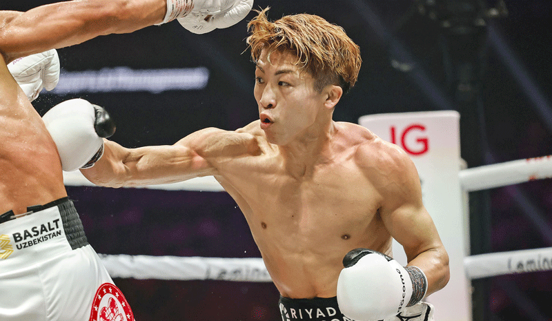 Japanese champion Naoya Inoue (R) takes on challenger Murodjon Akhmadaliev of Uzbekistan in the third round of their boxing match.