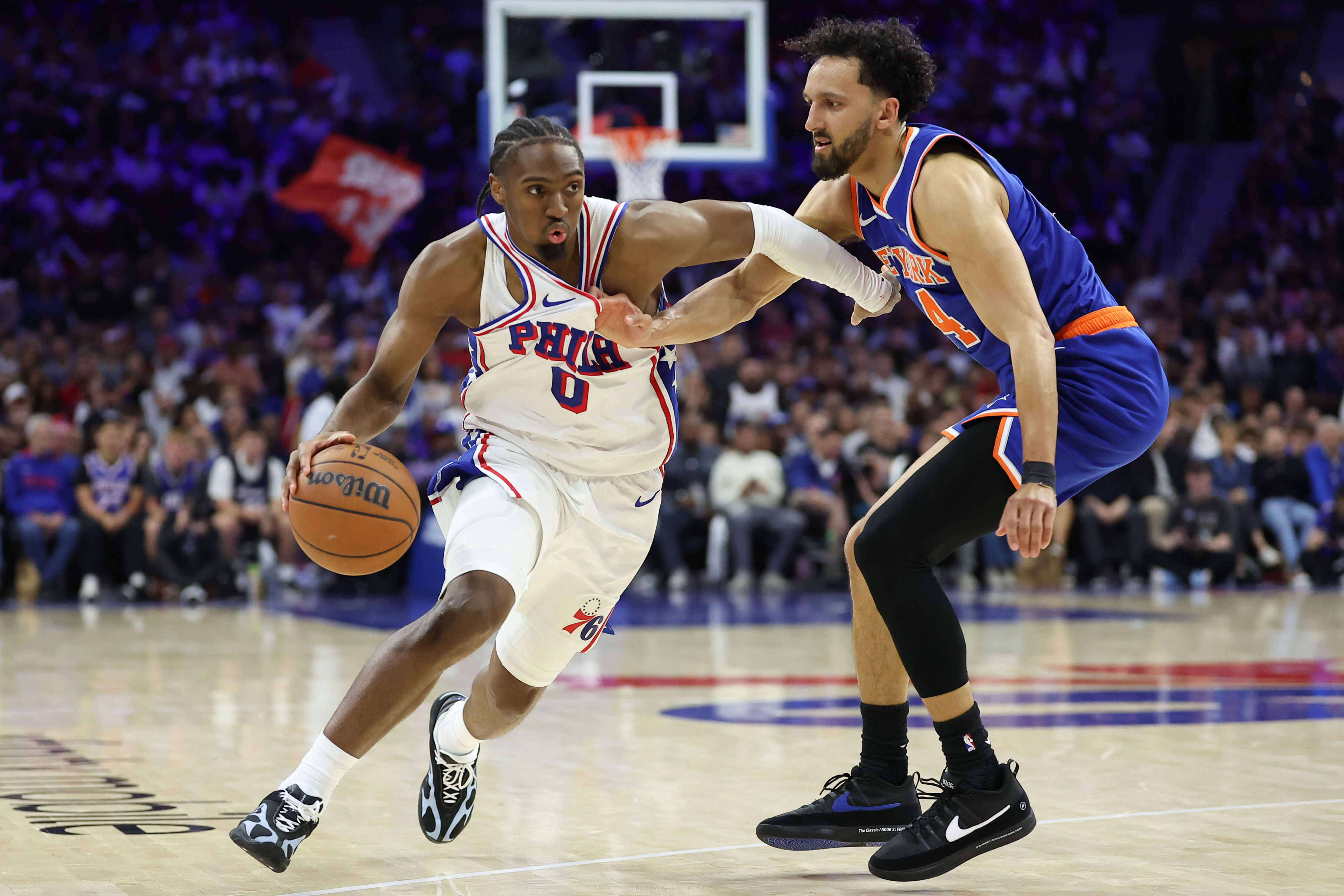 Philadelphia 76ers guard Tyrese Maxey (0) drives against New York Knicks guard Landry Shamet (44) during the fourth quarter of game three of the second round of the 2026 NBA Playoffs at Xfinity Mobile Arena.
