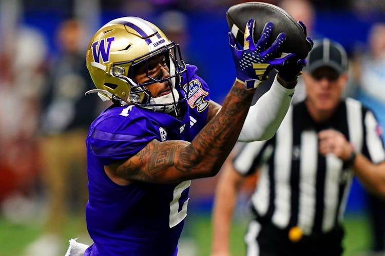 Washington Huskies wide receiver Ja'Lynn Polk (2) catches a touchdown pass during the second quarter against the Texas Longhorns in the 2024 Sugar Bowl college football playoff semifinal game at Caesars Superdome.