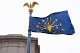 The Indiana state flag flies outside the Indiana Statehouse, Wednesday, March 6, 2024, in Indianapolis.