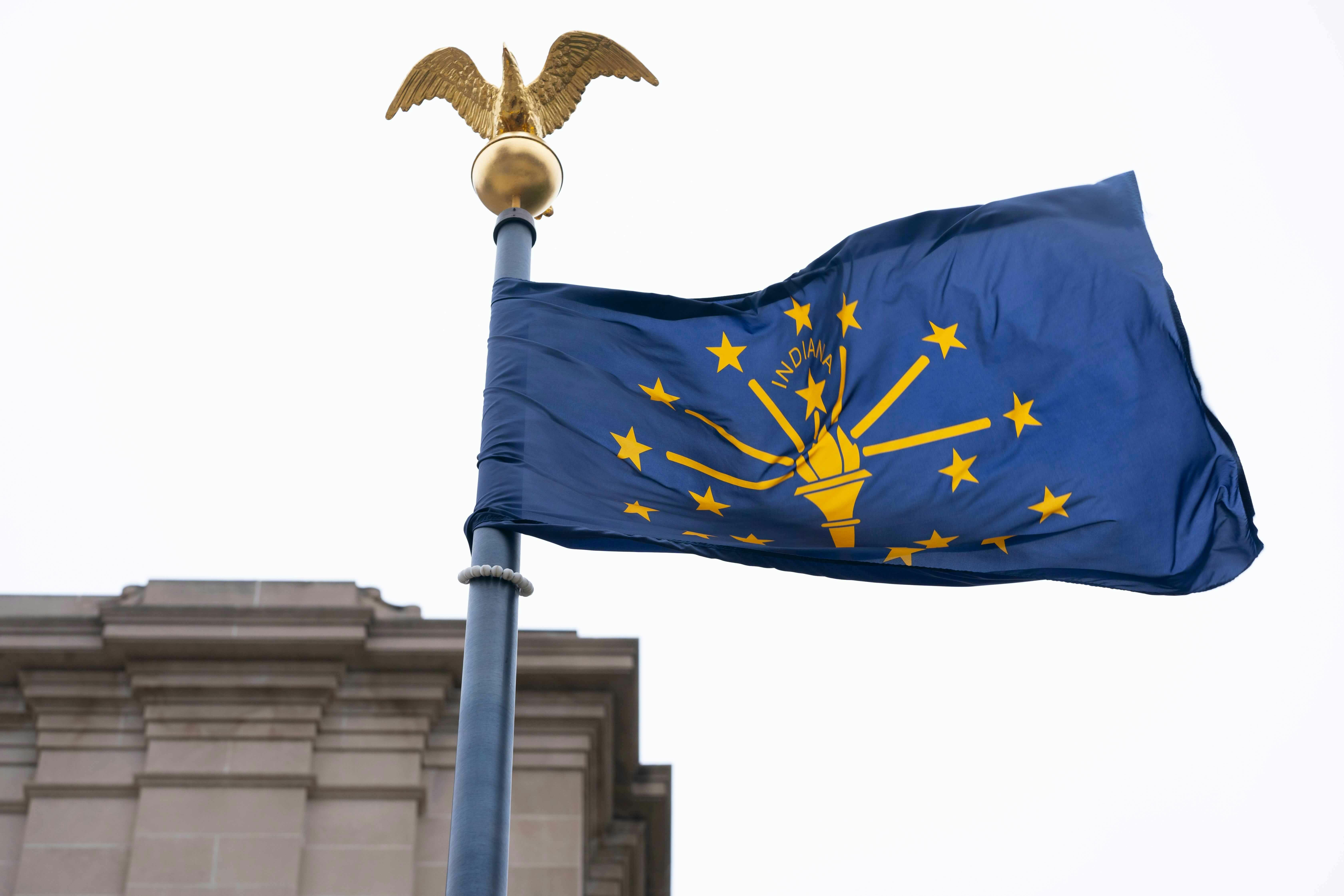 The Indiana state flag flies outside the Indiana Statehouse, Wednesday, March 6, 2024, in Indianapolis.