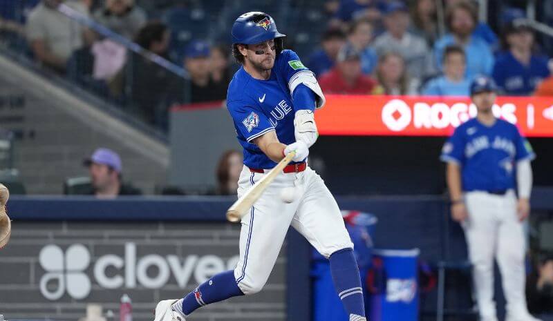 Toronto Blue Jays second baseman Ernie Clement (22) hits a single.