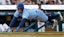 Toronto Blue Jays outfielder George Springer (4) dives in safe at home.