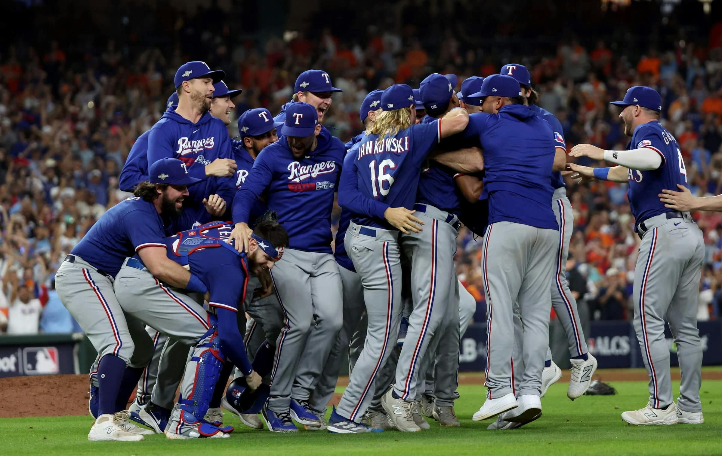 Texas Rangers players celebrate after winning game seven in the ALCS against the Houston Astros for the 2023 MLB playoffs at Minute Maid Park.