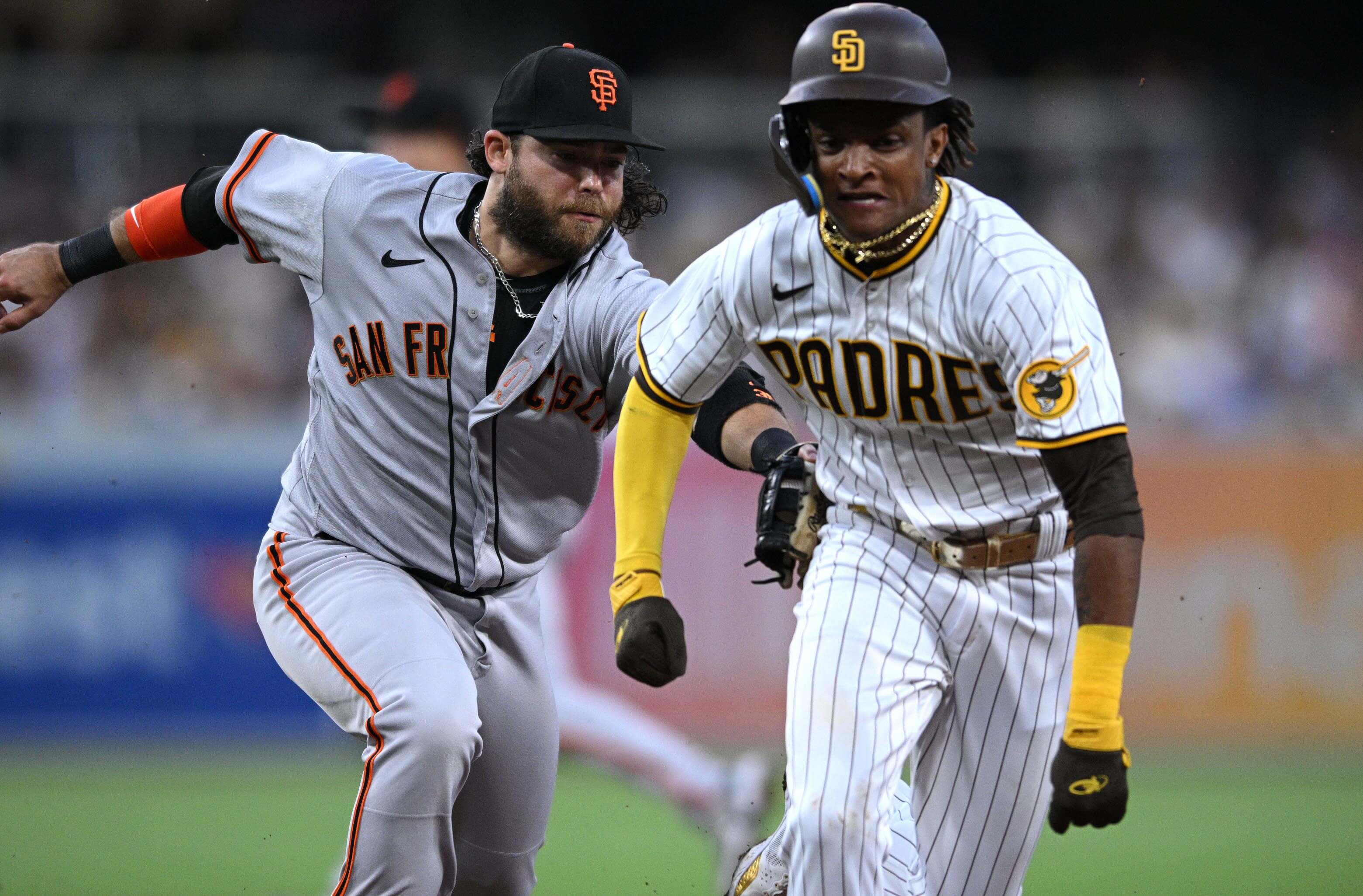 an Francisco Giants shortstop Brandon Crawford (left) tags San Diego Padres shortstop baseman C.J. Abrams (right) out after being caught in a rundown attempting to steal second base during the third inning at Petco Park.