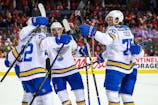 St. Louis Blues center Pius Suter (22) celebrates his goal with teammates against the Calgary Flames during the third period at Scotiabank Saddledome. Sergei Belski-Imagn Images