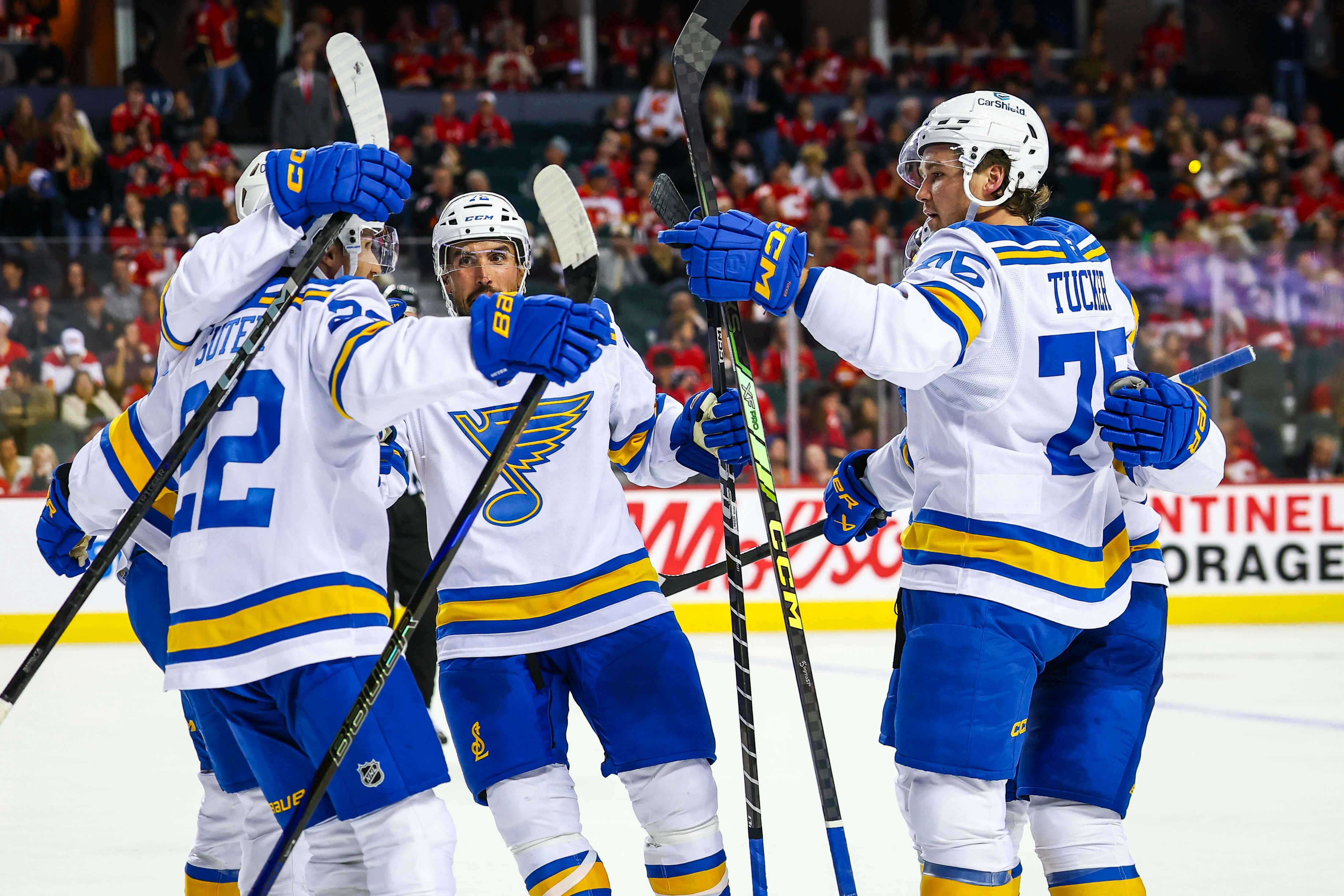 St. Louis Blues center Pius Suter (22) celebrates his goal with teammates against the Calgary Flames during the third period at Scotiabank Saddledome. Sergei Belski-Imagn Images