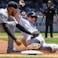 Detroit Tigers shortstop Harold Castro (30) tags out New York Yankees second baseman DJ LeMahieu (26) at third base during the third inning at Yankee Stadium.