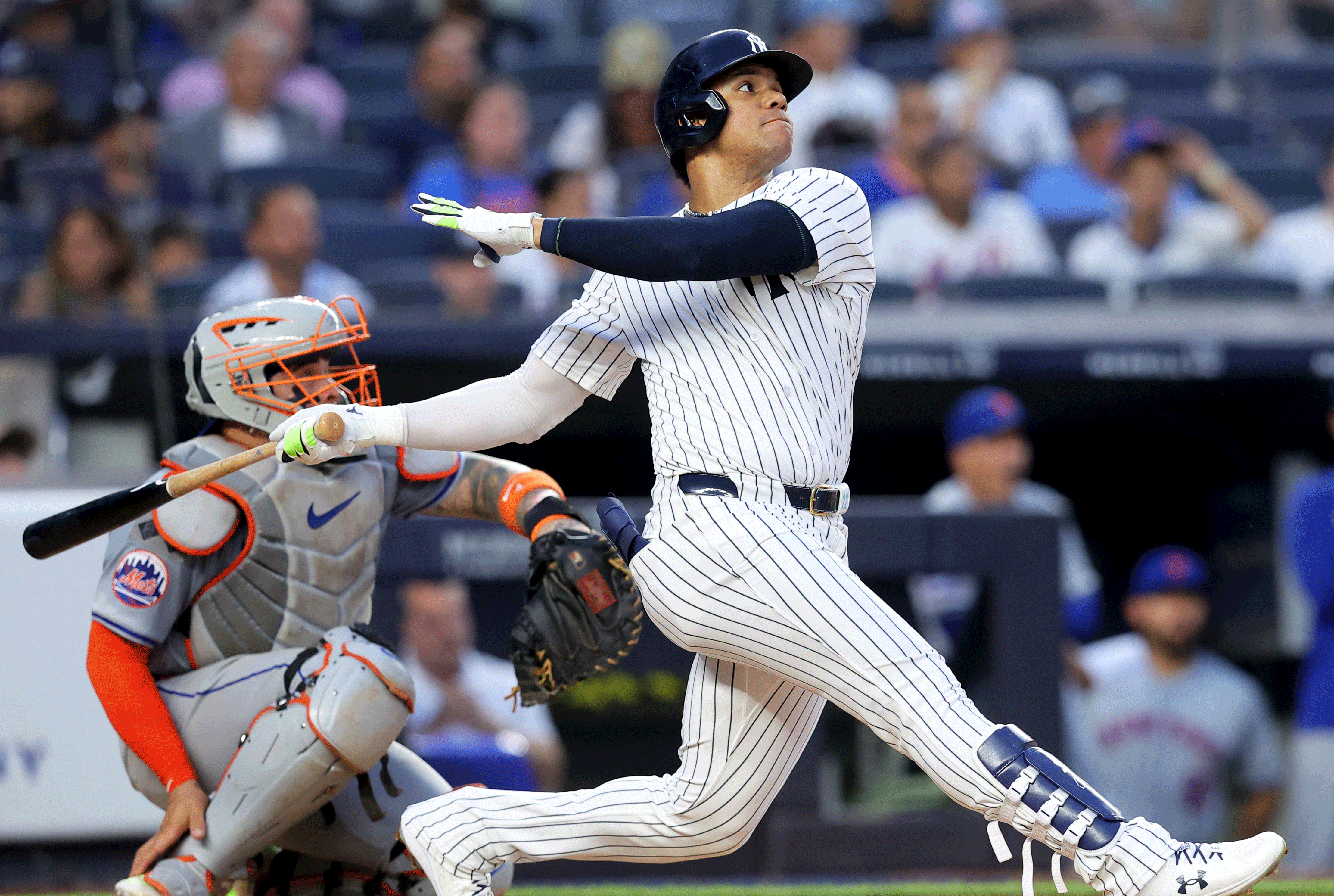 New York Yankees right fielder Juan Soto (22) follows through on a solo home run against the New York Mets during the third inning at Yankee Stadium. Mandatory Credit: Brad Penner-Imagn Images