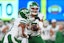 New York Jets quarterback Justin Fields (7) hands off to running back Braelon Allen (0)