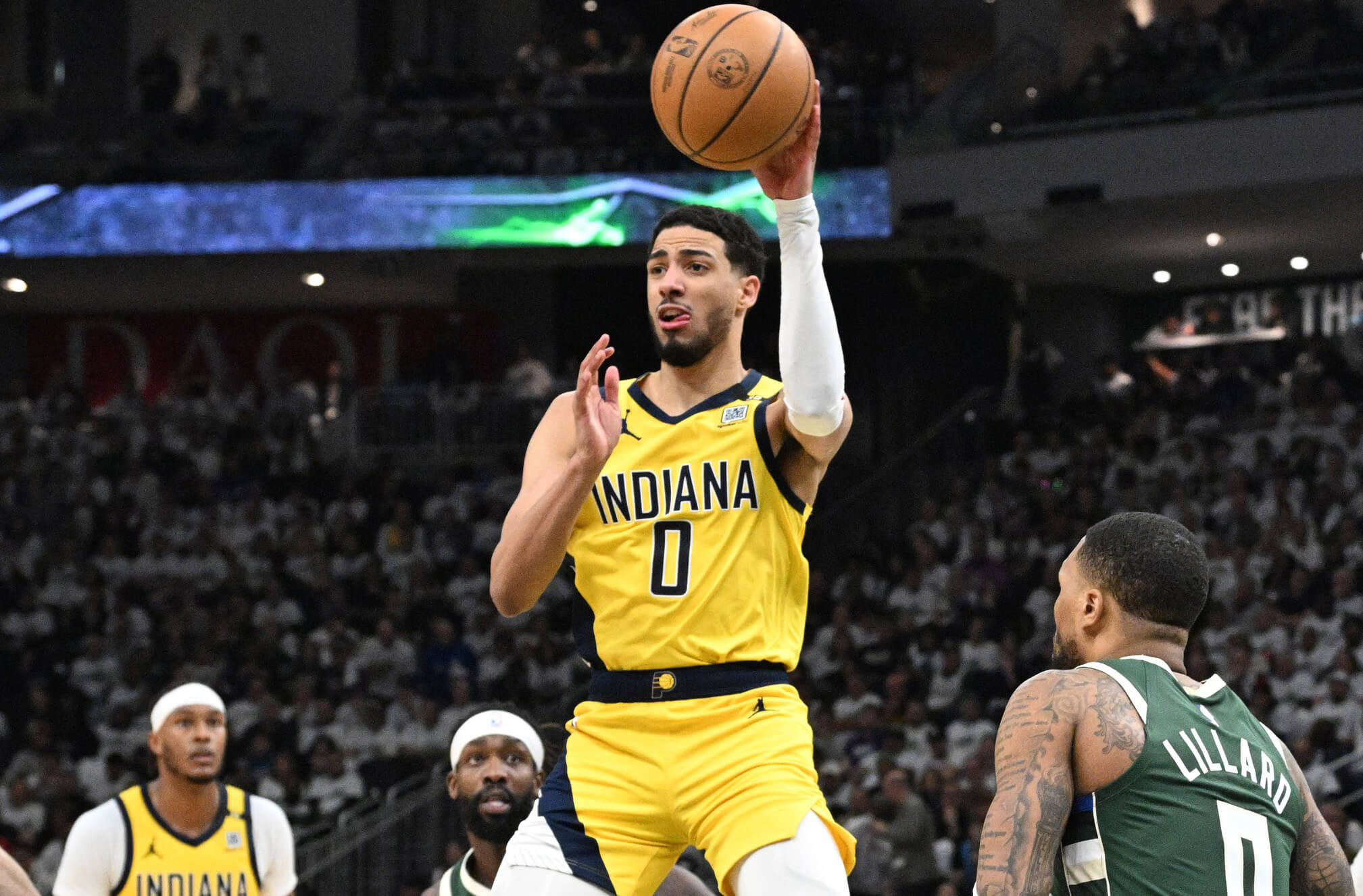  Indiana Pacers guard Tyrese Haliburton (0) makes a pass against the Milwaukee Bucks guard Damian Lillard (0) in the second half during game two of the first round for the 2024 NBA playoffs at Fiserv Forum. 