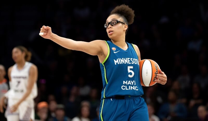  Minnesota Lynx guard Olivia Miles (5) holds her arm out.