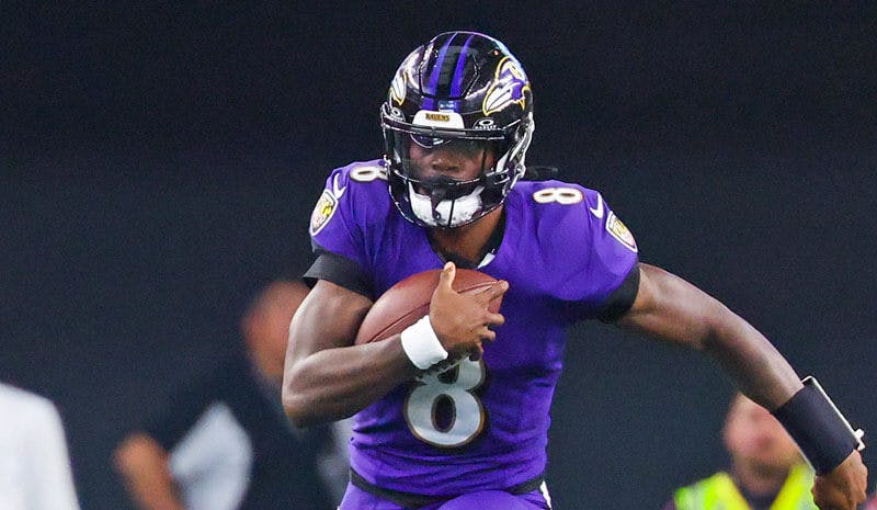 Baltimore Ravens quarterback Lamar Jackson sprints towards the end zone.