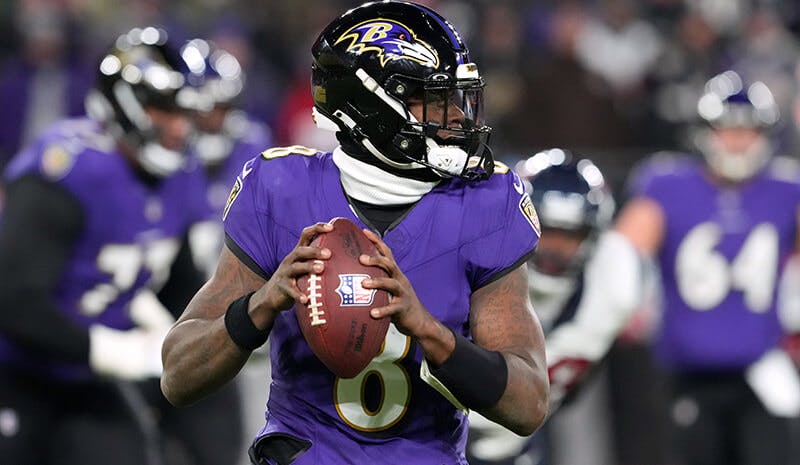 Baltimore, MD, USA; Baltimore Ravens quarterback Lamar Jackson (8) rolls out to throw against the Houston Texans during the second quarter of a 2024 AFC divisional round game at M&T Bank Stadium.