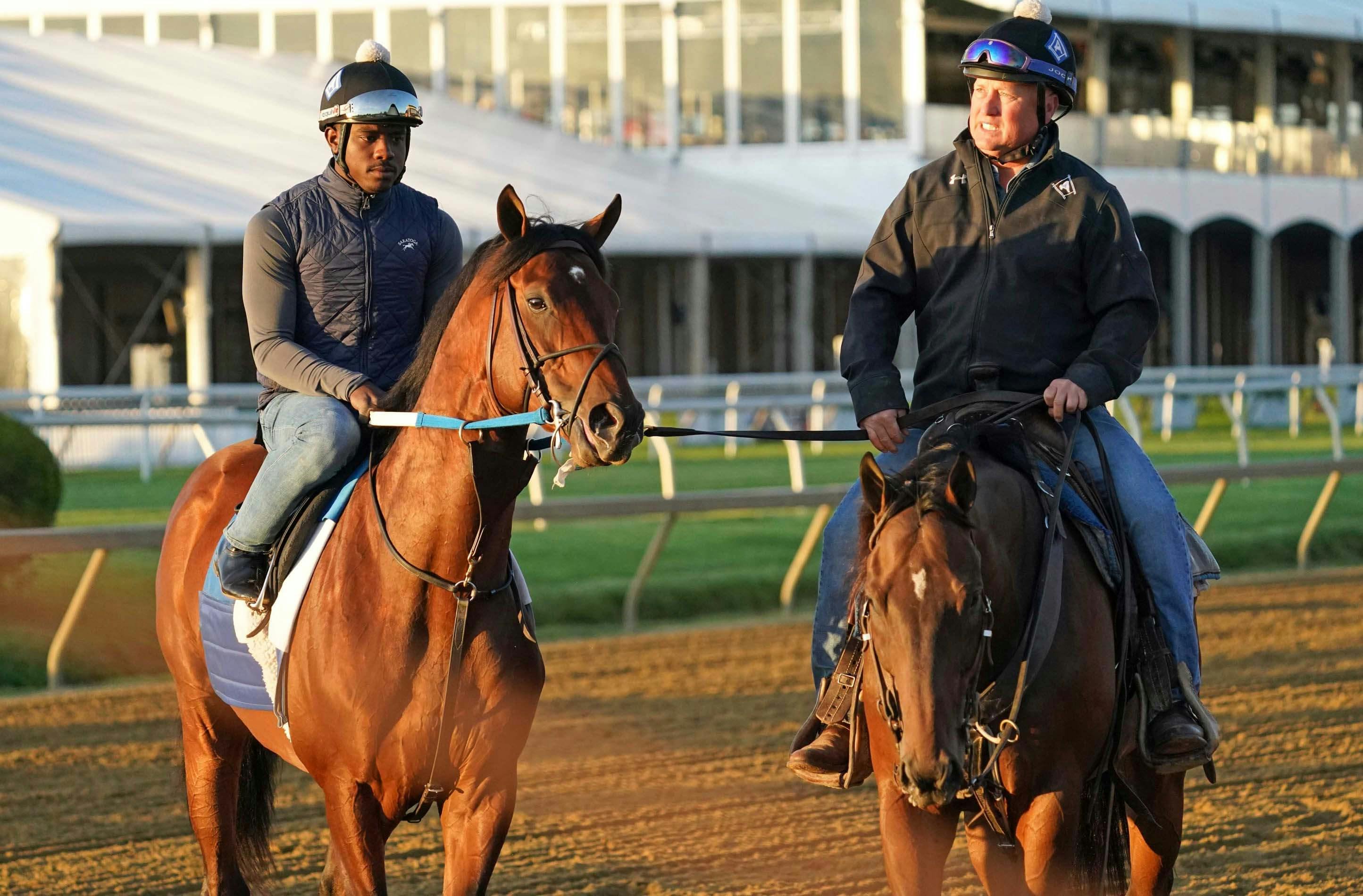 Epicenter (left) being led off the track following morning workouts at Pimlico Race Course.