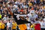 Missouri Tigers wide receiver Marquis Johnson (2) is unable to make a catch against Kansas Jayhawks defensive back Jalen Todd (26) during the first half at Faurot Field at Memorial Stadium. Jay Biggerstaff-Imagn Images
