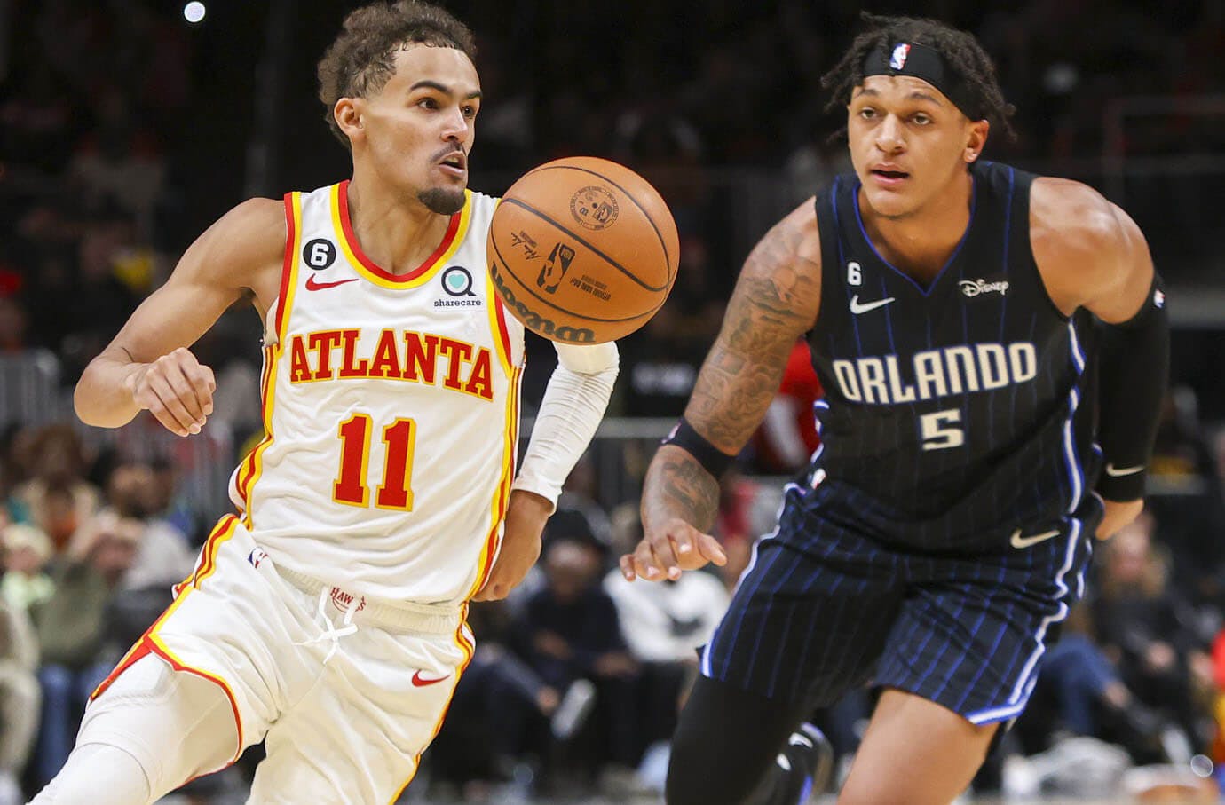 Atlanta Hawks guard Trae Young (11) dribbles past Orlando Magic forward Paolo Banchero (5) in the second half at State Farm Arena.