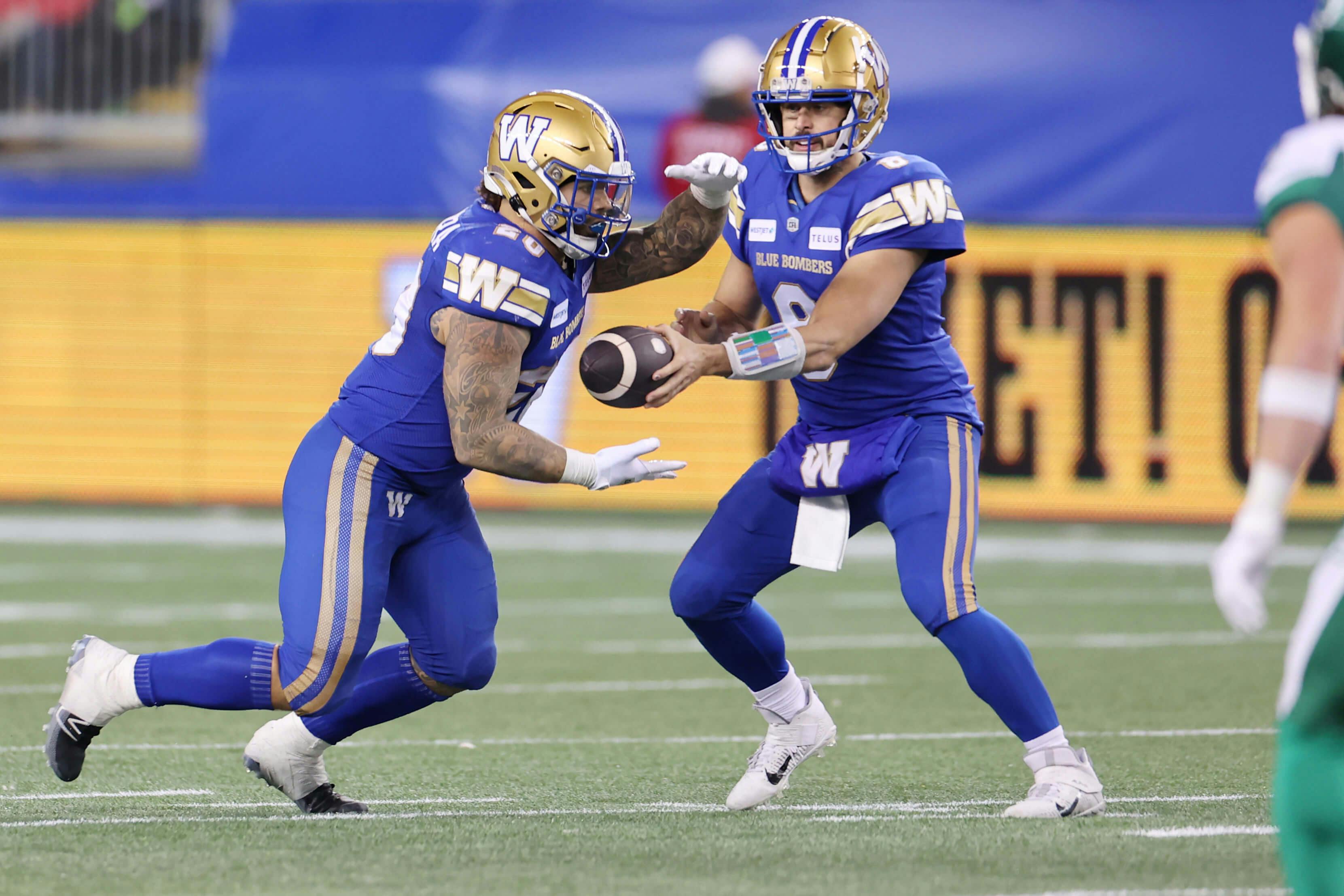 Winnipeg Blue Bombers running back Brady Oliveira (20) takes a handoff from quarterback Zach Collaros (8) against the Saskatchewan Roughriders.