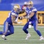 Winnipeg Blue Bombers running back Brady Oliveira (20) takes a handoff from quarterback Zach Collaros (8) against the Saskatchewan Roughriders.