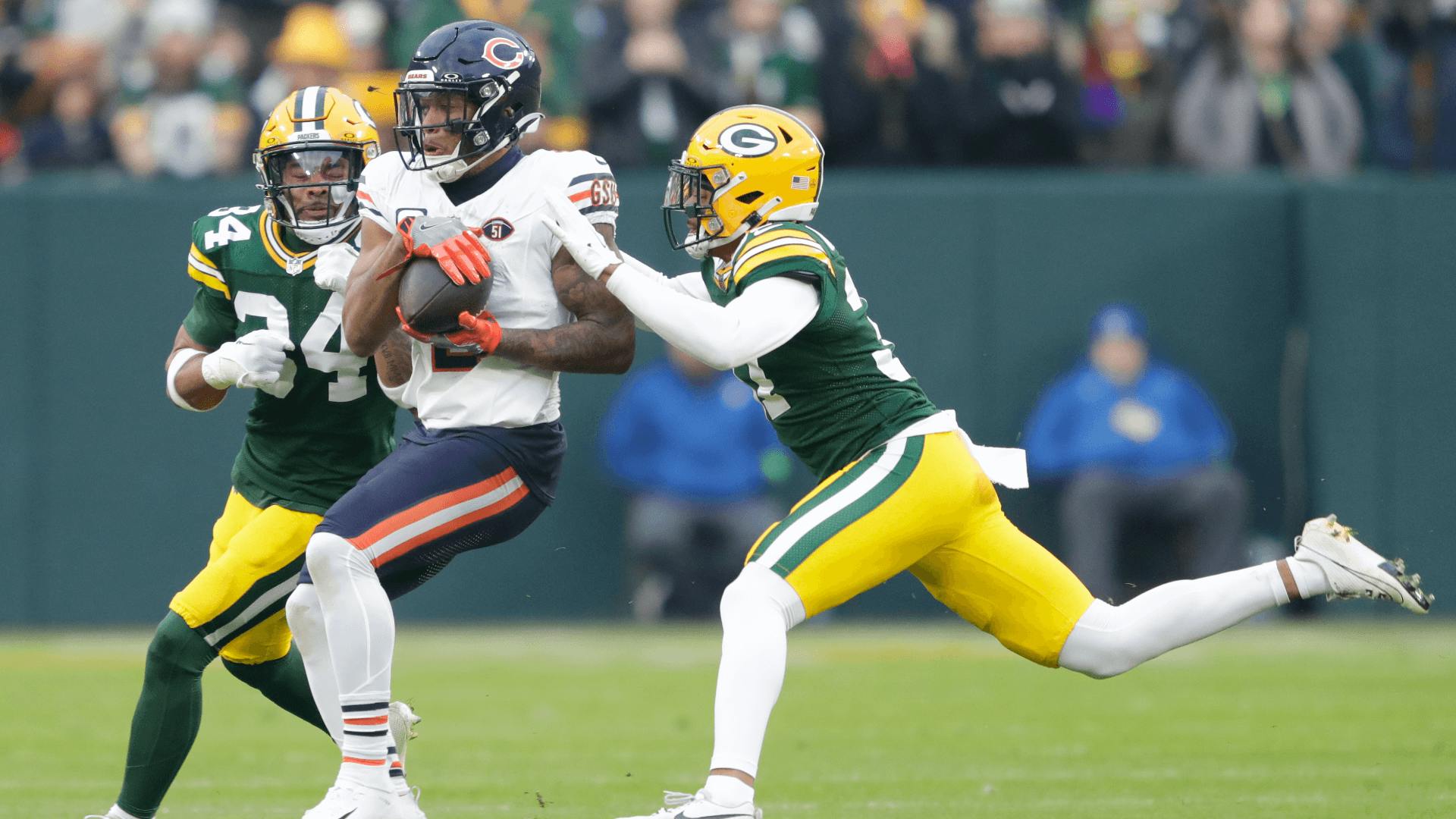 Chicago Bears wide receiver DJ Moore (2) catches a first down pass against Green Bay Packers safety Jonathan Owens (34) and cornerback Carrington Valentine (37).