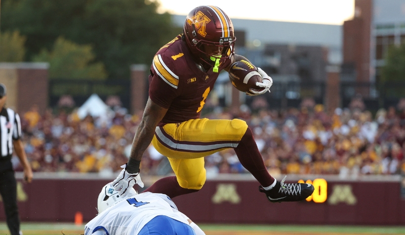 Minnesota Golden Gophers running back Darius Taylor (1) hurdles.
