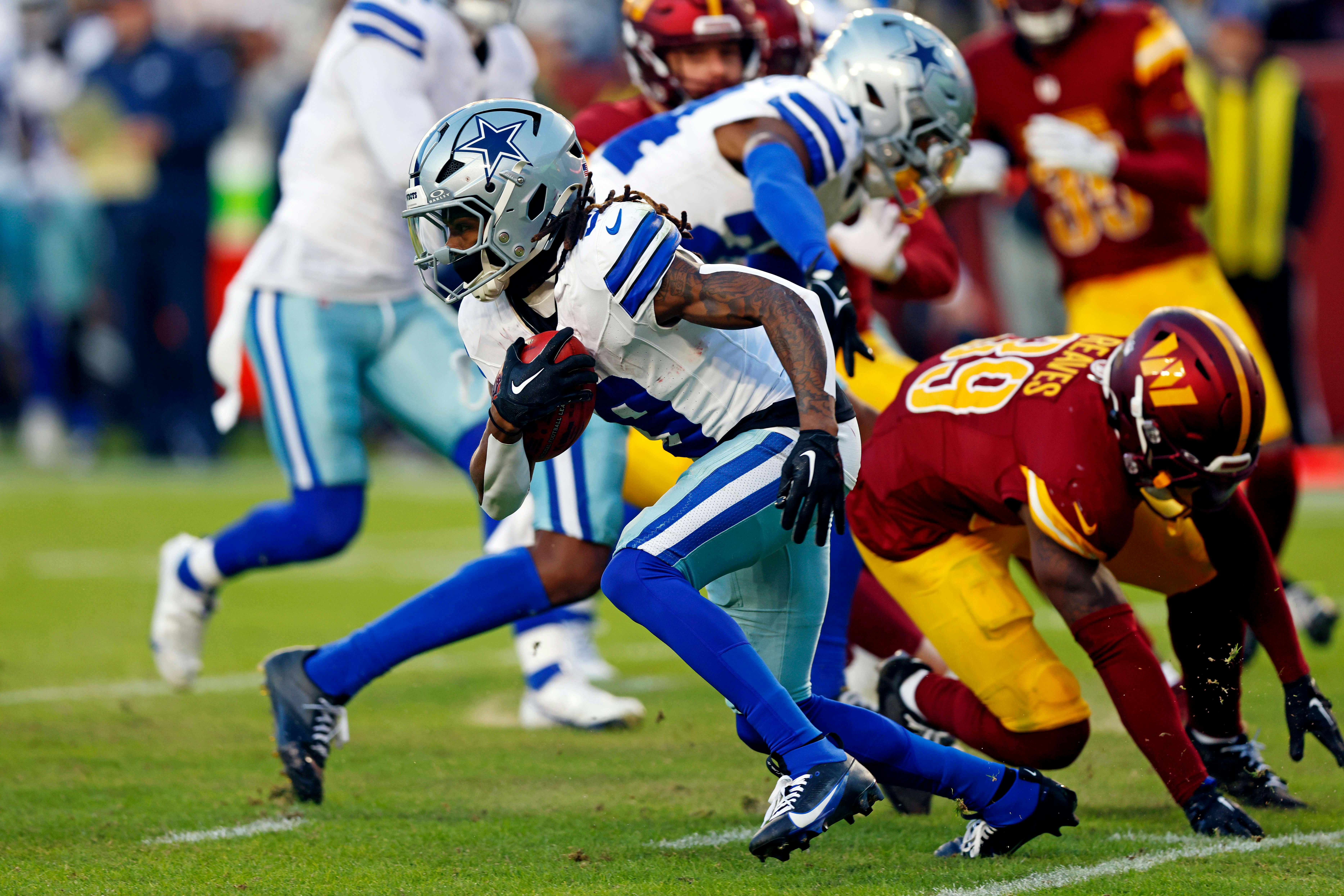 Dallas Cowboys wide receiver KaVontae Turpin (9) breaks a tackle by Washington Commanders safety Jeremy Reaves (39) to run for a touchdown on a kickoff return during the fourth quarter at Northwest Stadium. Mandatory Credit: Peter Casey-Imagn Images