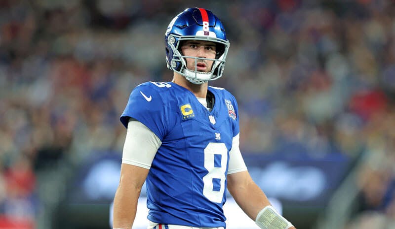 Imagn Images. Pictured: Daniel Jones walks off the field after throwing an interception. 