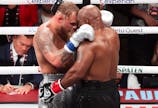 Mike Tyson (black gloves) hugs Jake Paul (silver gloves) after their fight at AT&T Stadium. Mandatory Credit: Kevin Jairaj-Imagn Images