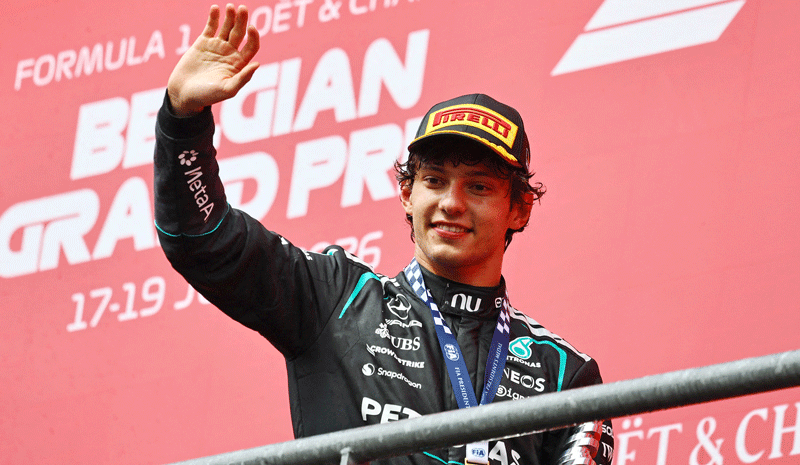Kimi Antonelli celebrates with a trophy on the podium after winning the Belgian Grand Prix