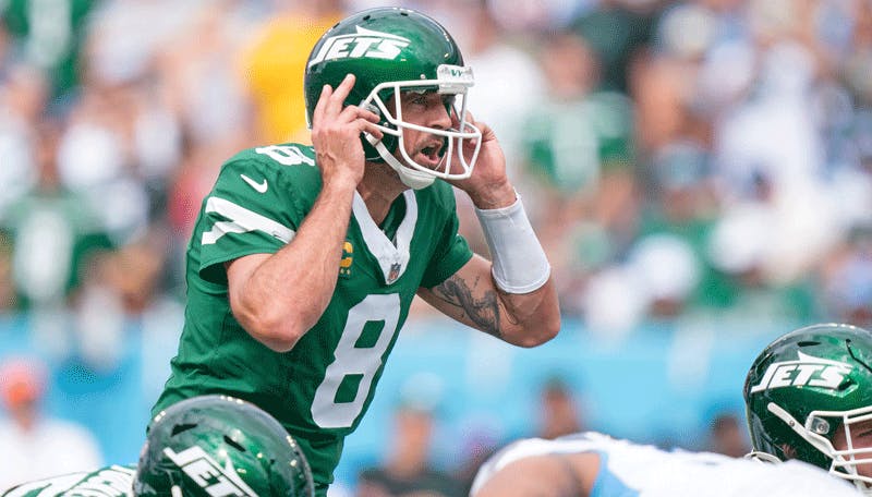 New York Jets quarterback Aaron Rodgers calls out a play at the line of scrimmage.