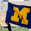 Michigan flag being carried at college game