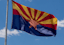 An American flag and an Arizona flag fly outside the office of the county attorney on June 12, 2024, in St. Johns, Arizona.