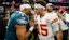 Eagles quarterback Jalen Hurts (1) greets Chiefs quarterback Patrick Mahomes (15).