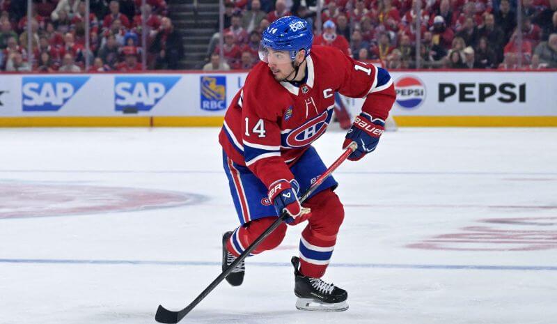  Montreal Canadiens forward Nick Suzuki (14) plays the puck.