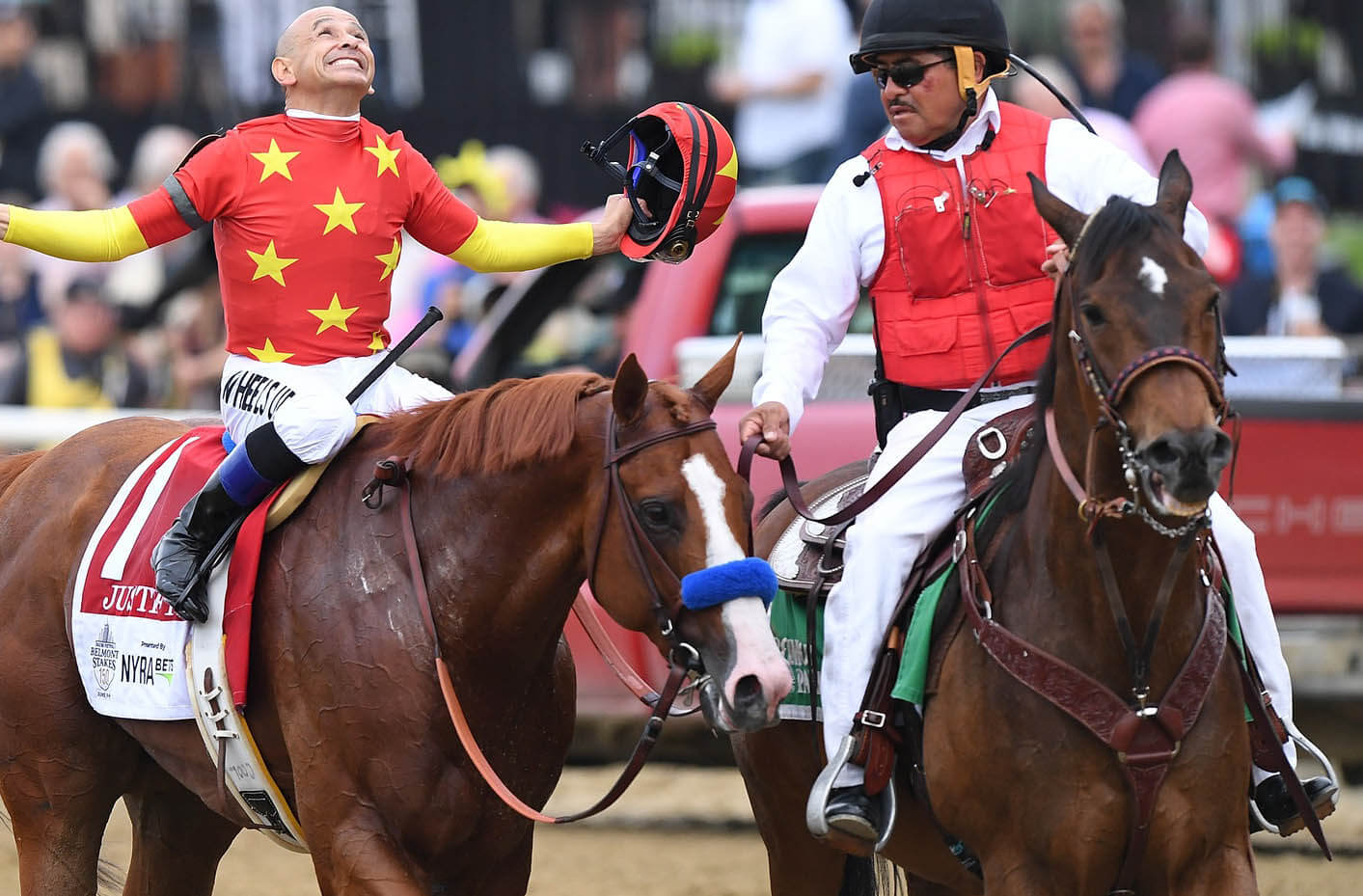 Mike Smith aboard Justify (1) celebrates on the trot back after winning the 150th Belmont Stakes and the Triple Crown at Belmont Park.