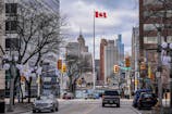 The Detroit skyline can be seen past the Canadian flag in Windsor, Ontario, across the Detroit River, Thursday, March 6, 2025. Kimberly P. Mitchell / USA TODAY NETWORK via Imagn Images