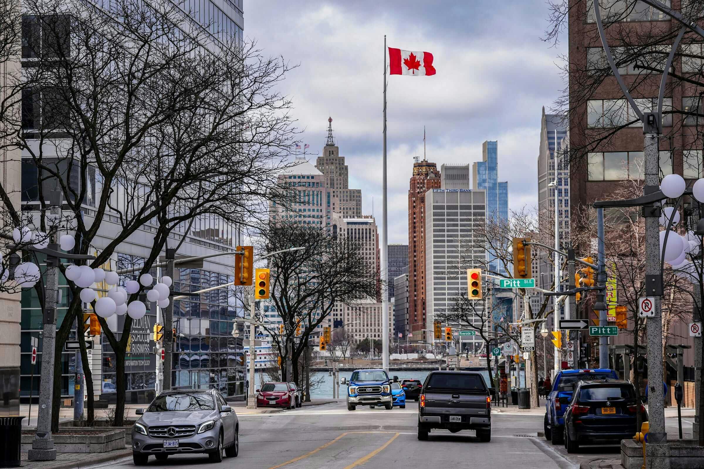 The Detroit skyline can be seen past the Canadian flag in Windsor, Ontario, across the Detroit River, Thursday, March 6, 2025. Kimberly P. Mitchell / USA TODAY NETWORK via Imagn Images