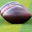 Footballs lined up on a football field.