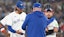 Toronto Blue Jays pitcher Kevin Gausman (34) hands the ball to manager John Schneider (14) 