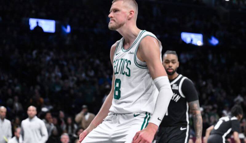 Boston Celtics center Kristaps Porzingis (8) reacts after dunking the ball.