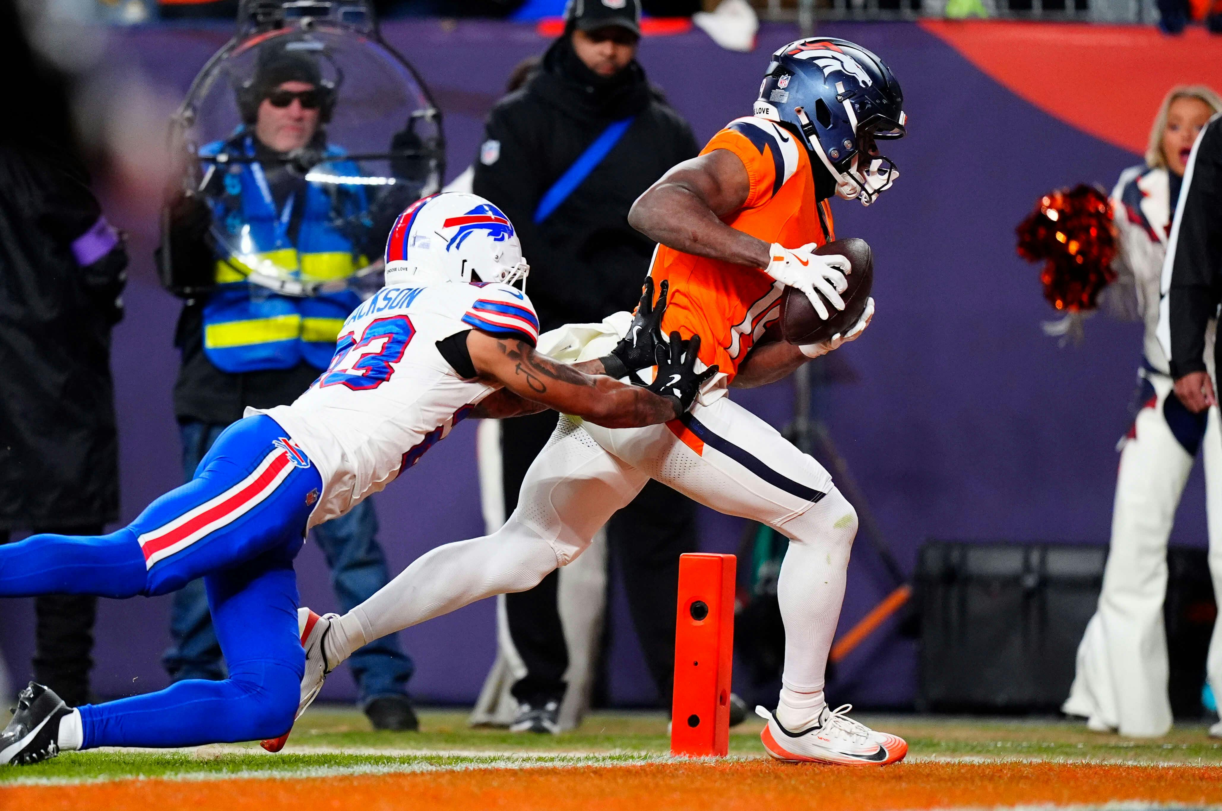 Denver Broncos wide receiver Marvin Mims Jr. (19) catches a touchdown against Buffalo Bills cornerback Dane Jackson (23) during the fourth quarter of an AFC Divisional Round playoff game at Empower Field at Mile High. Ron Chenoy-Imagn Images