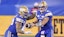 Winnipeg Blue Bombers running back Brady Oliveira (20) takes a handoff from quarterback Zach Collaros (8).